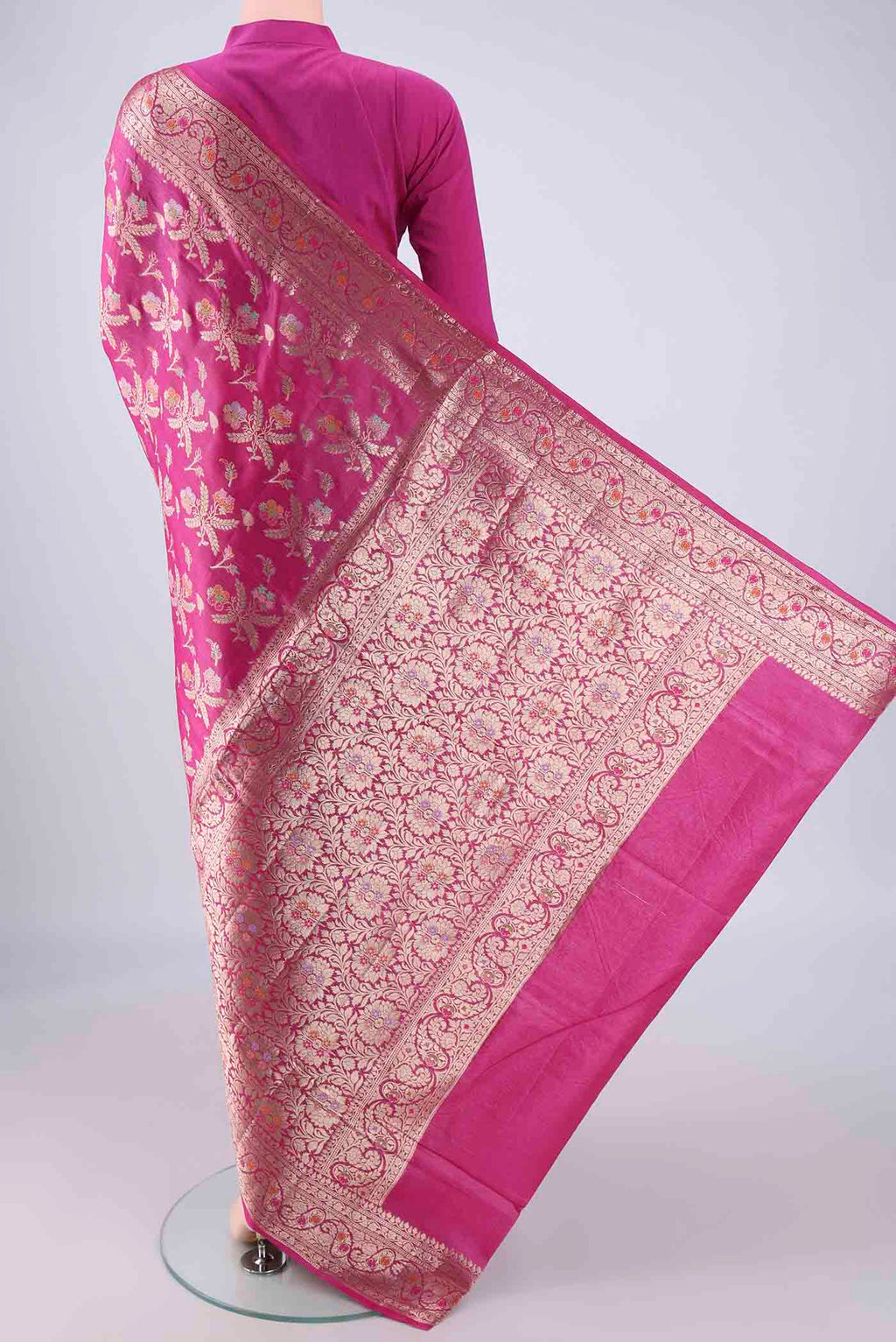 Flat view of Rani Pink Banarasi Tussar Silk Saree with Zari And Thread Butta on the body and Zari Border. 
