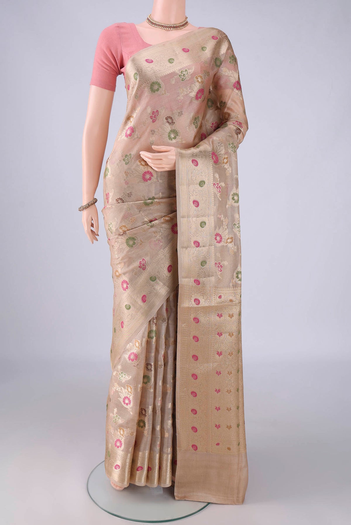 Beige Banarasi Tussar Saree with Zari And Thread Butta on the body and Zari Border.  displayed on a mannequin