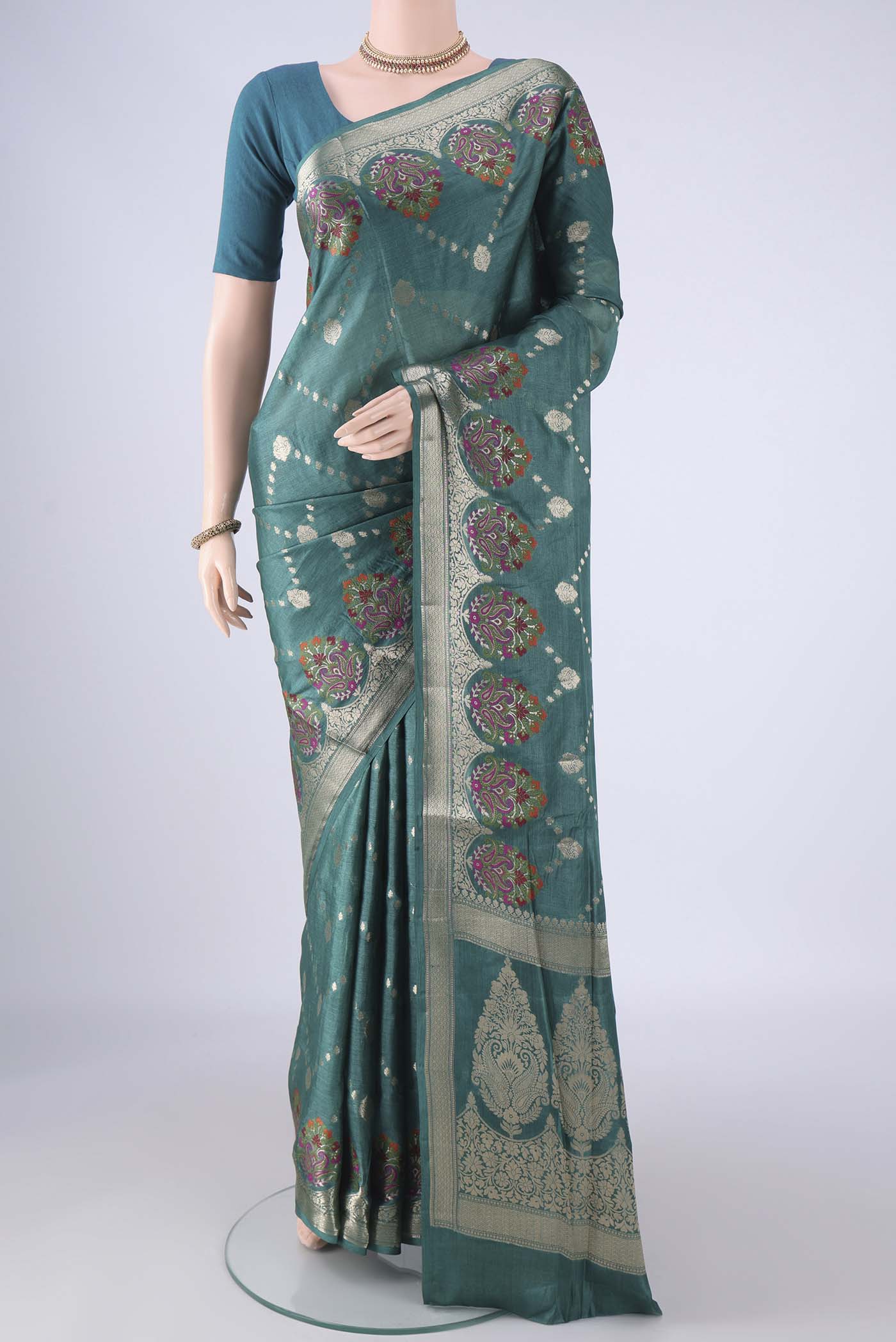 Sea Green Banarasi Tussar Silk Saree with Zari And Thread Butta on the body and Zari Border.  displayed on a mannequin
