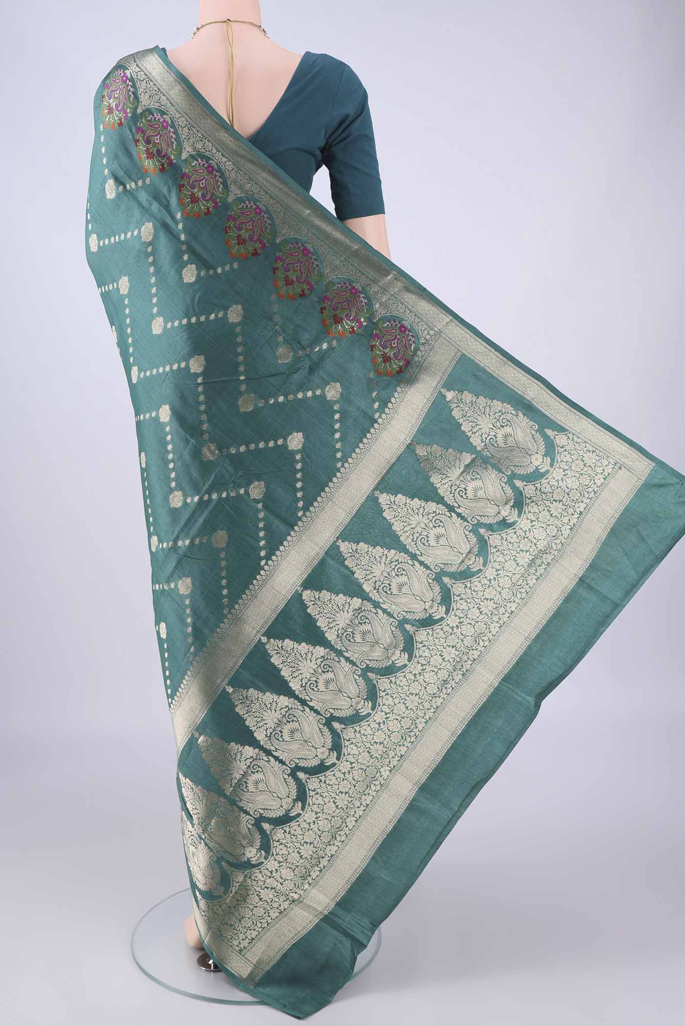 Flat view of Sea Green Banarasi Tussar Silk Saree with Zari And Thread Butta on the body and Zari Border. 