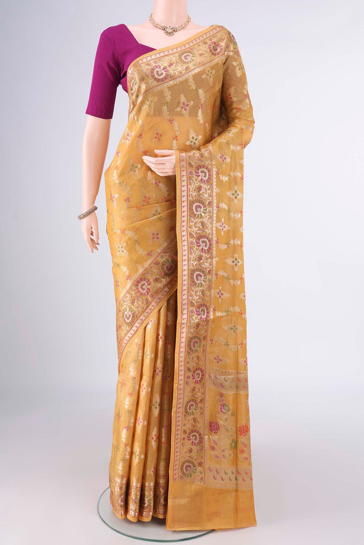 Mustard Banarasi Tussar Saree with Zari And Thread Butta on the body and Zari And Thread Border.  displayed on a mannequin