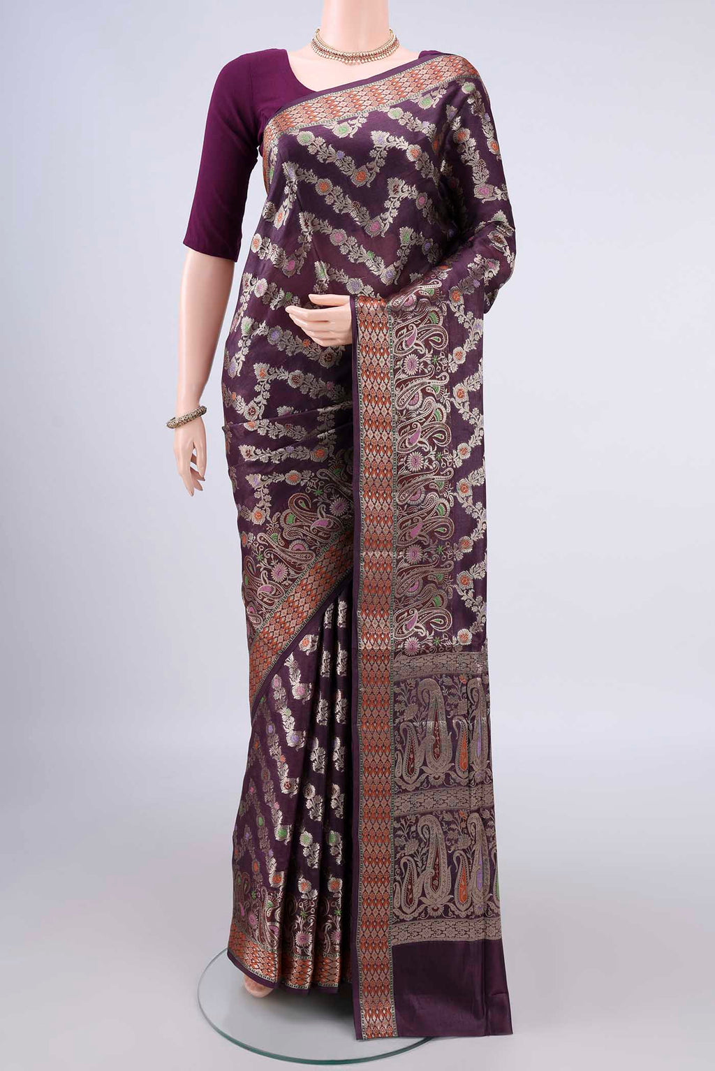 Pure Silk Burgundy Banarasi Raw Saree with Zari And Thread Butta on the body and Zari Border.  displayed on a mannequin