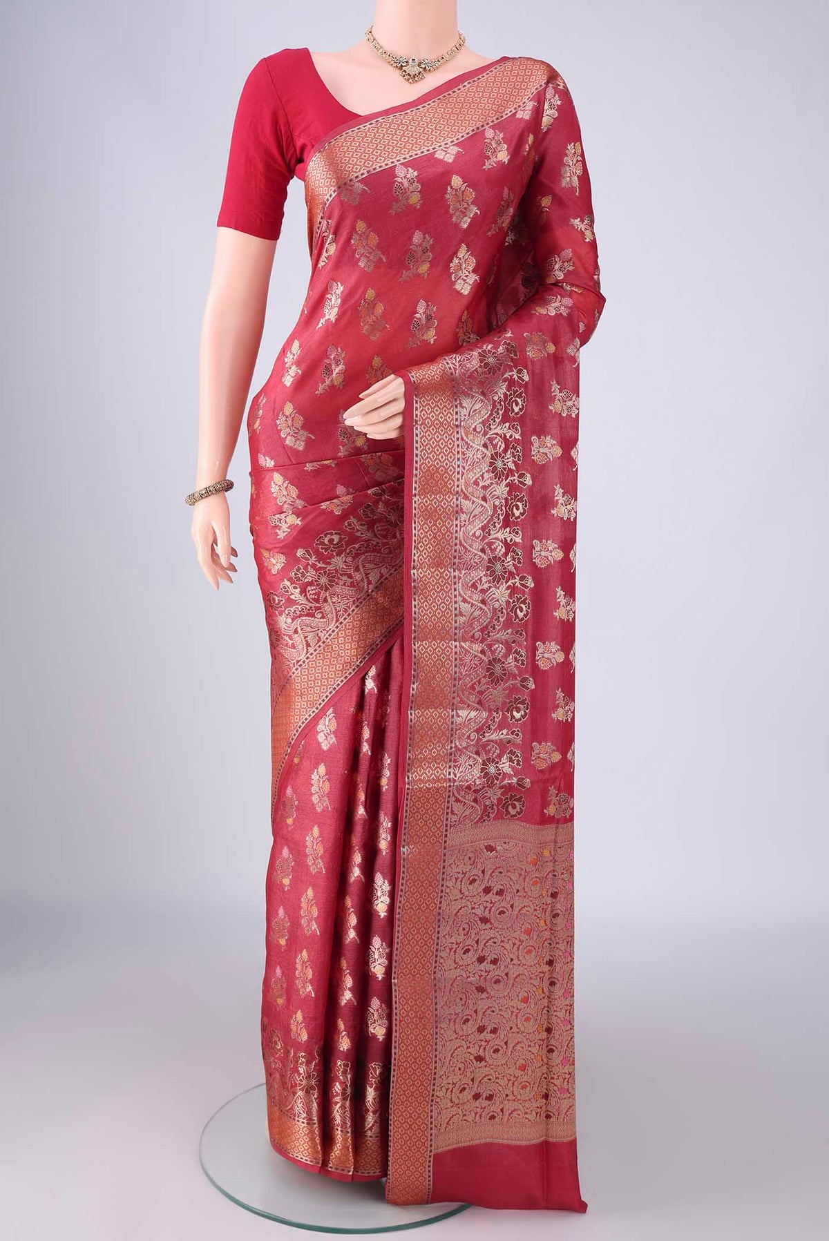Coral Banarasi Tussar Silk Saree with Zari And Thread Butta on the body and Zari Border.  displayed on a mannequin