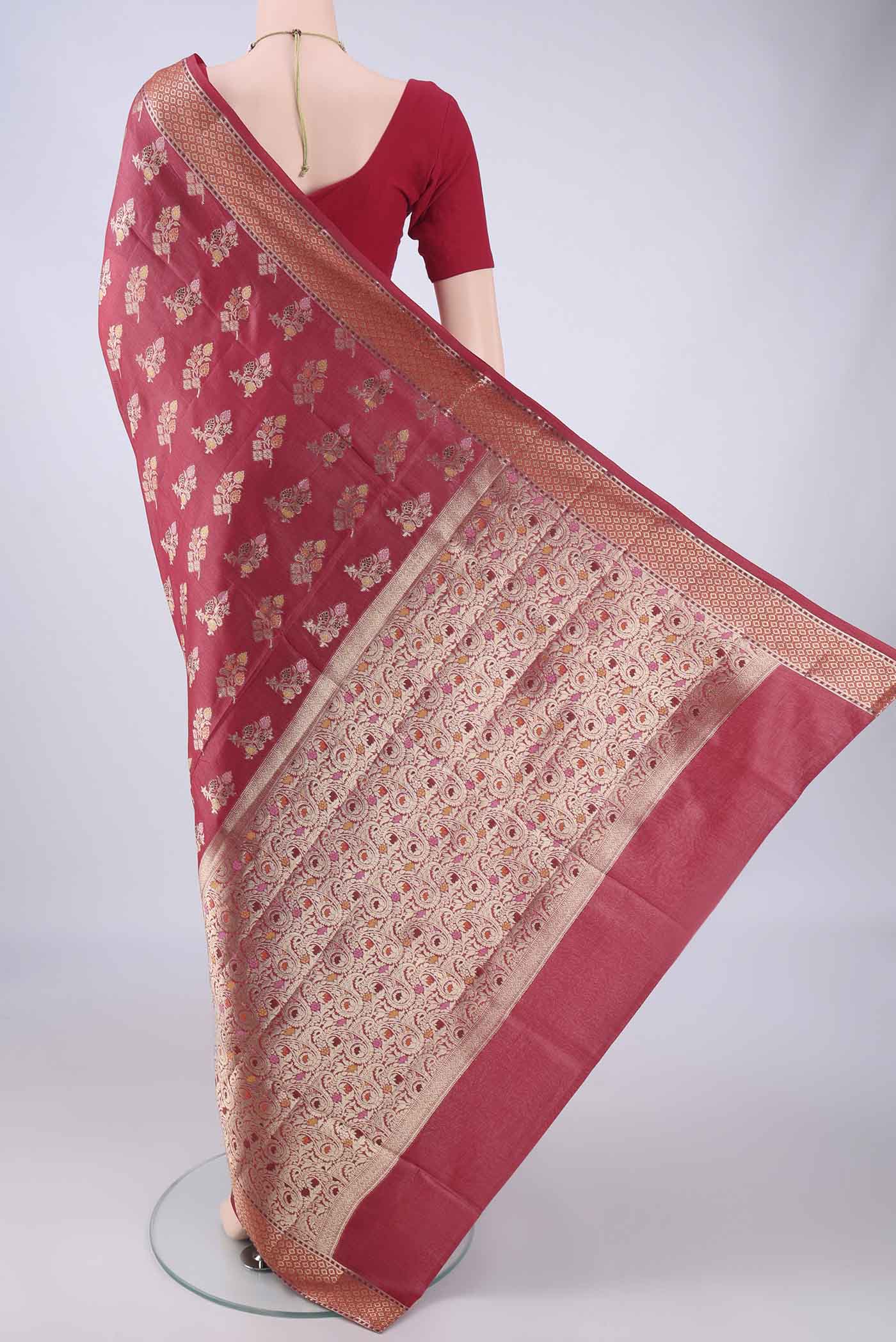 Flat view of Coral Banarasi Tussar Silk Saree with Zari And Thread Butta on the body and Zari Border. 