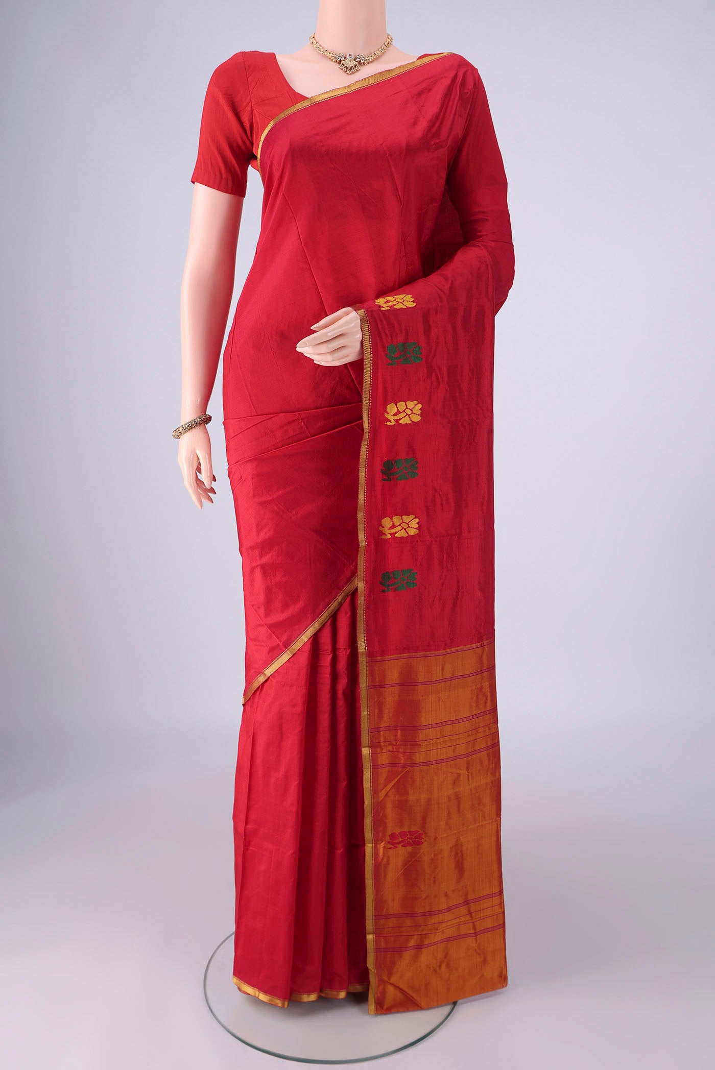 Red Kanchipuram Silk Saree with Plain Body and Thread Border.  displayed on a mannequin