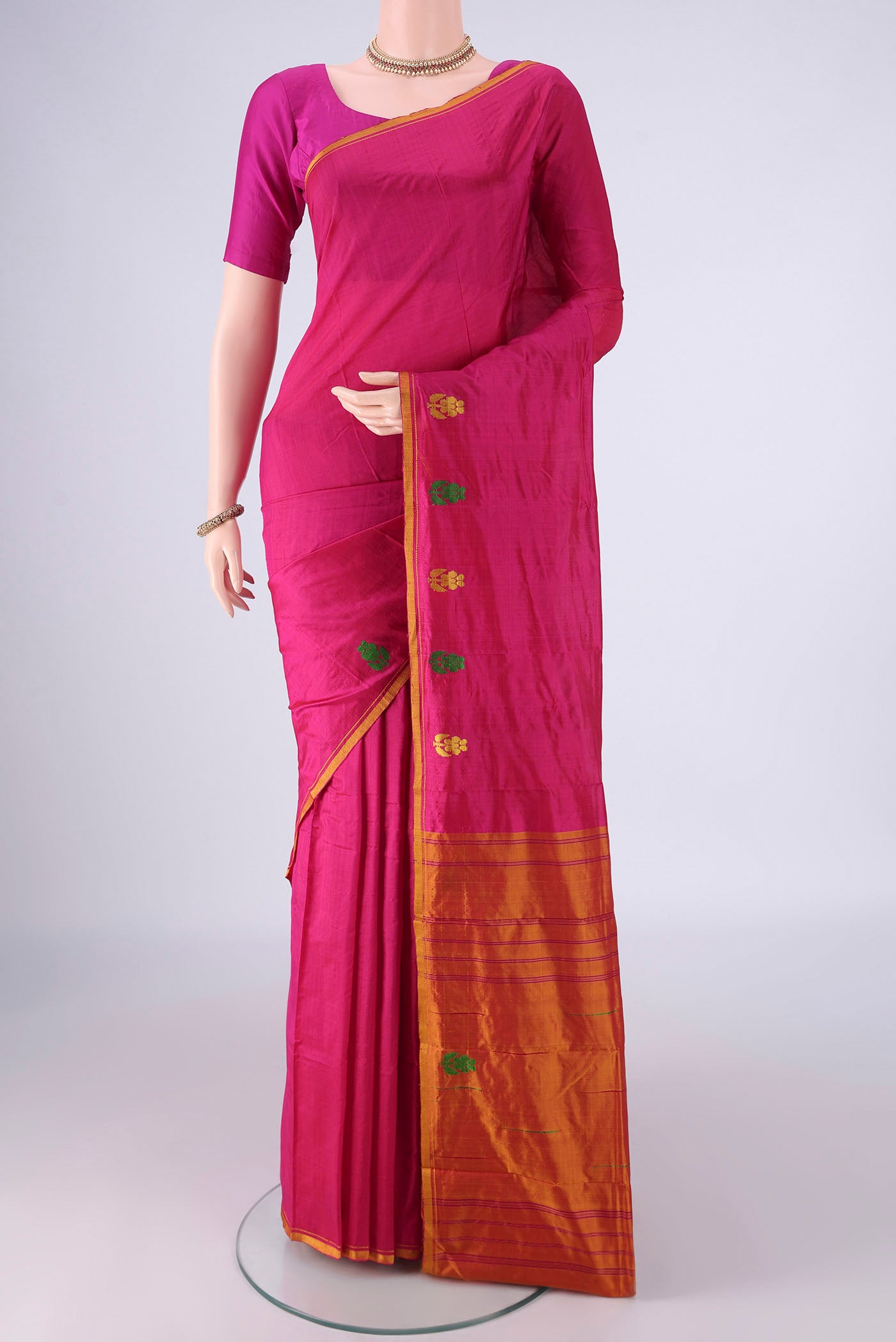 Rani Pink Kanchipuram Silk Saree with Plain Body and Thread Border.  displayed on a mannequin