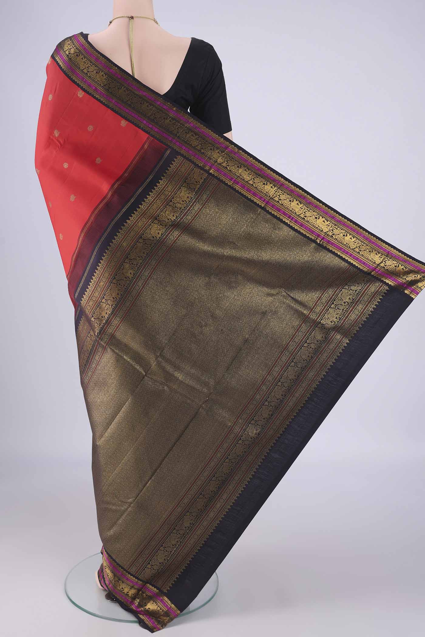 Flat view of Orange Kanjivaram Silk Saree with Zari Butta on the body and Zari Border. 