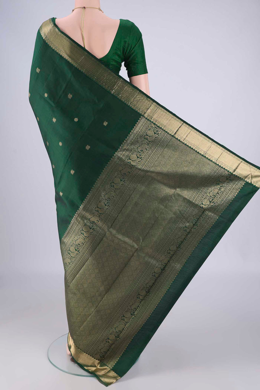Flat view of Bottle Green Kanjivaram Silk Saree with Zari Butta on the body and Zari Border. 
