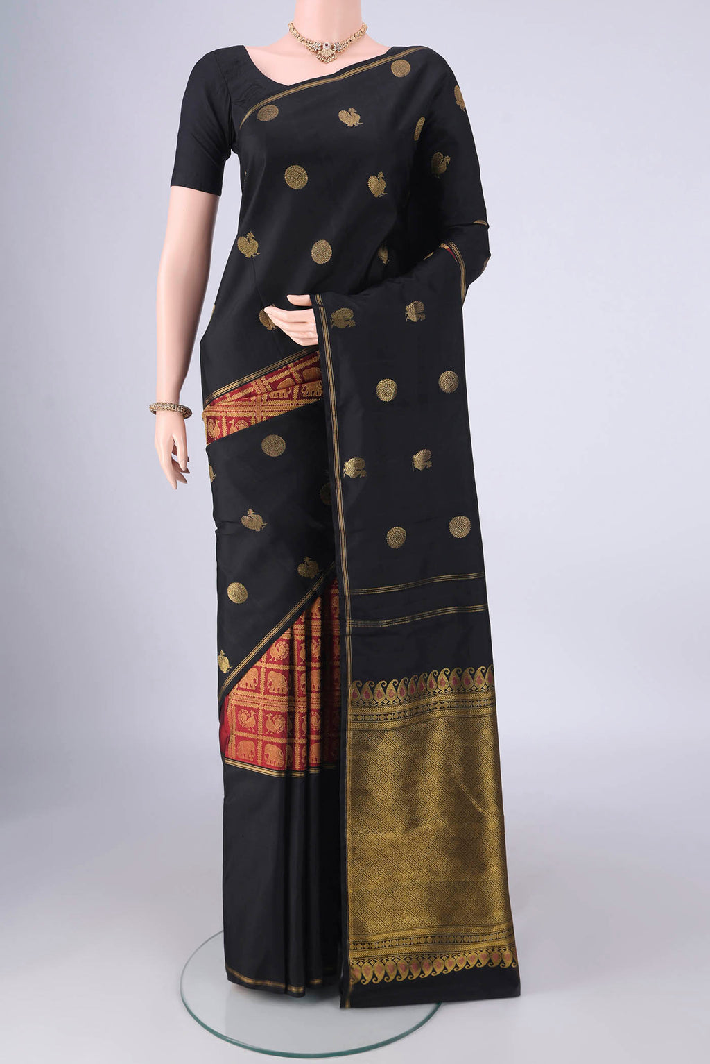 Multi Color Kanjivaram Silk Saree with Zari Butta on the body and Zari Border.  displayed on a mannequin