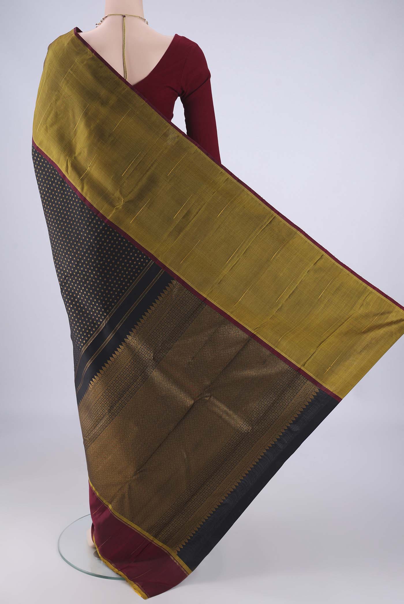 Flat view of Black Kanjivaram Silk Saree with Zari Butta on the body and Ganga Jamuna Border. 