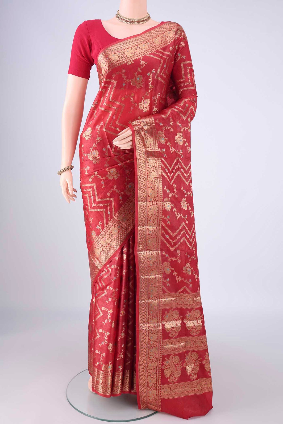 Red Banarasi Tussar Silk Saree with Zari And Thread Butta on the body and Zari Border.  displayed on a mannequin