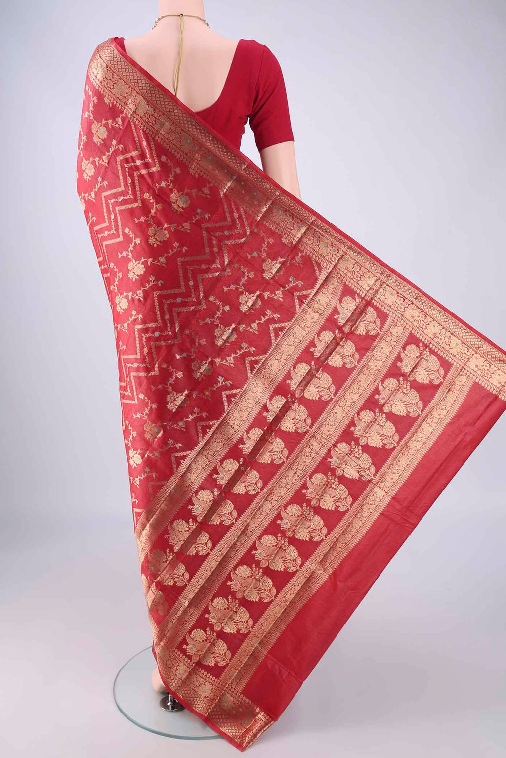 Flat view of Red Banarasi Tussar Silk Saree with Zari And Thread Butta on the body and Zari Border. 