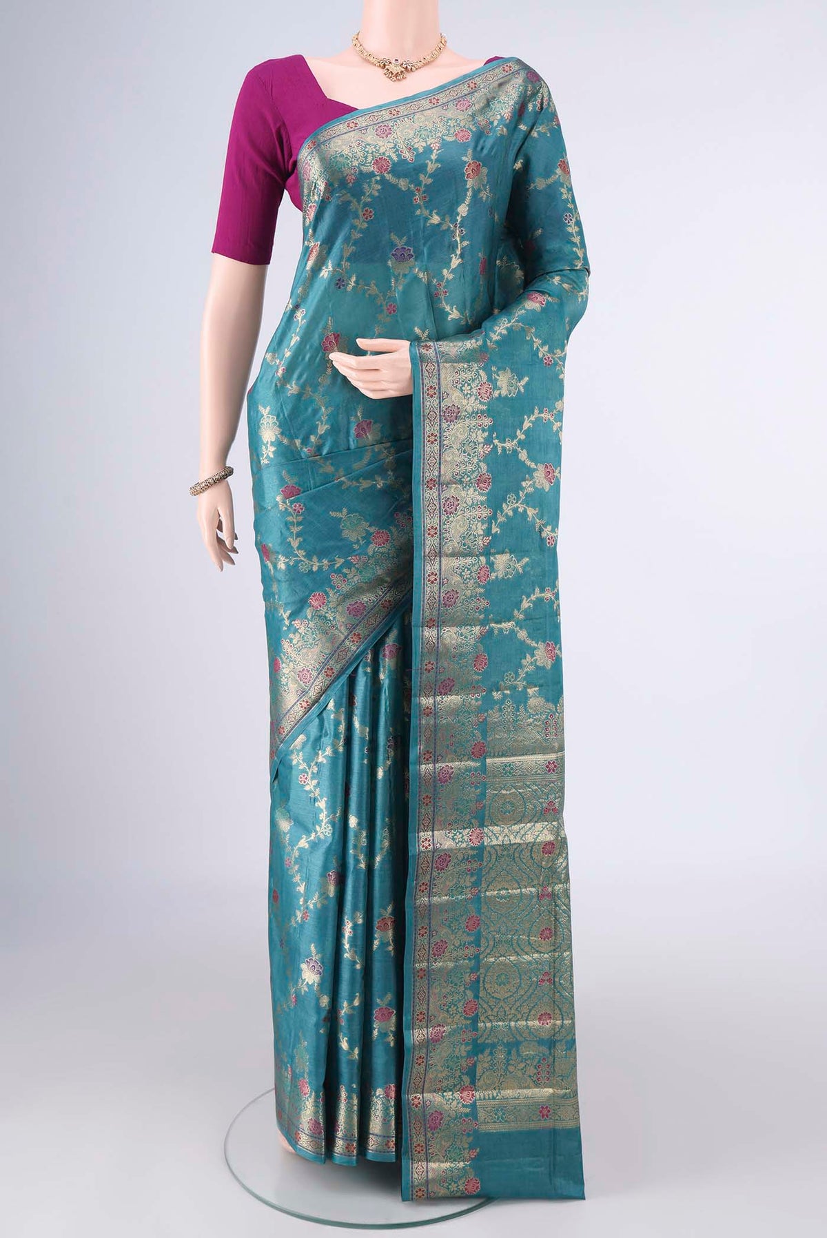 Sea Green Banarasi Tussar Saree with Zari And Thread Butta on the body and Zari And Thread Border.  displayed on a mannequin