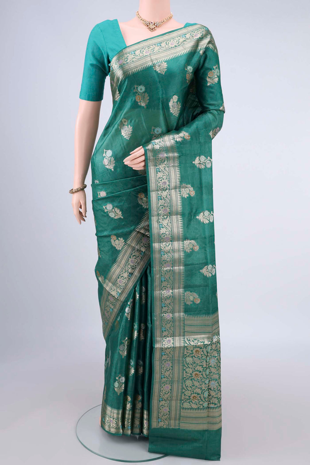 Sea Green Banarasi Tussar Saree with Zari And Thread Butta on the body and Zari Border.  displayed on a mannequin