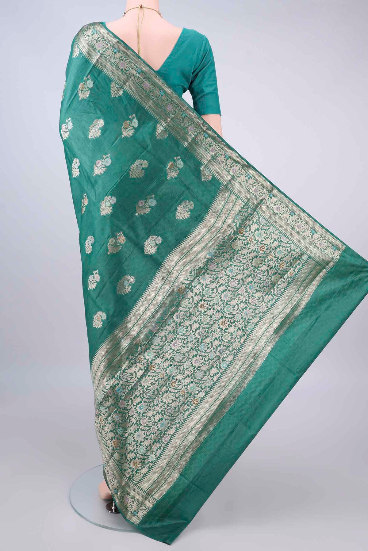 Flat view of Sea Green Banarasi Tussar Saree with Zari And Thread Butta on the body and Zari Border. 