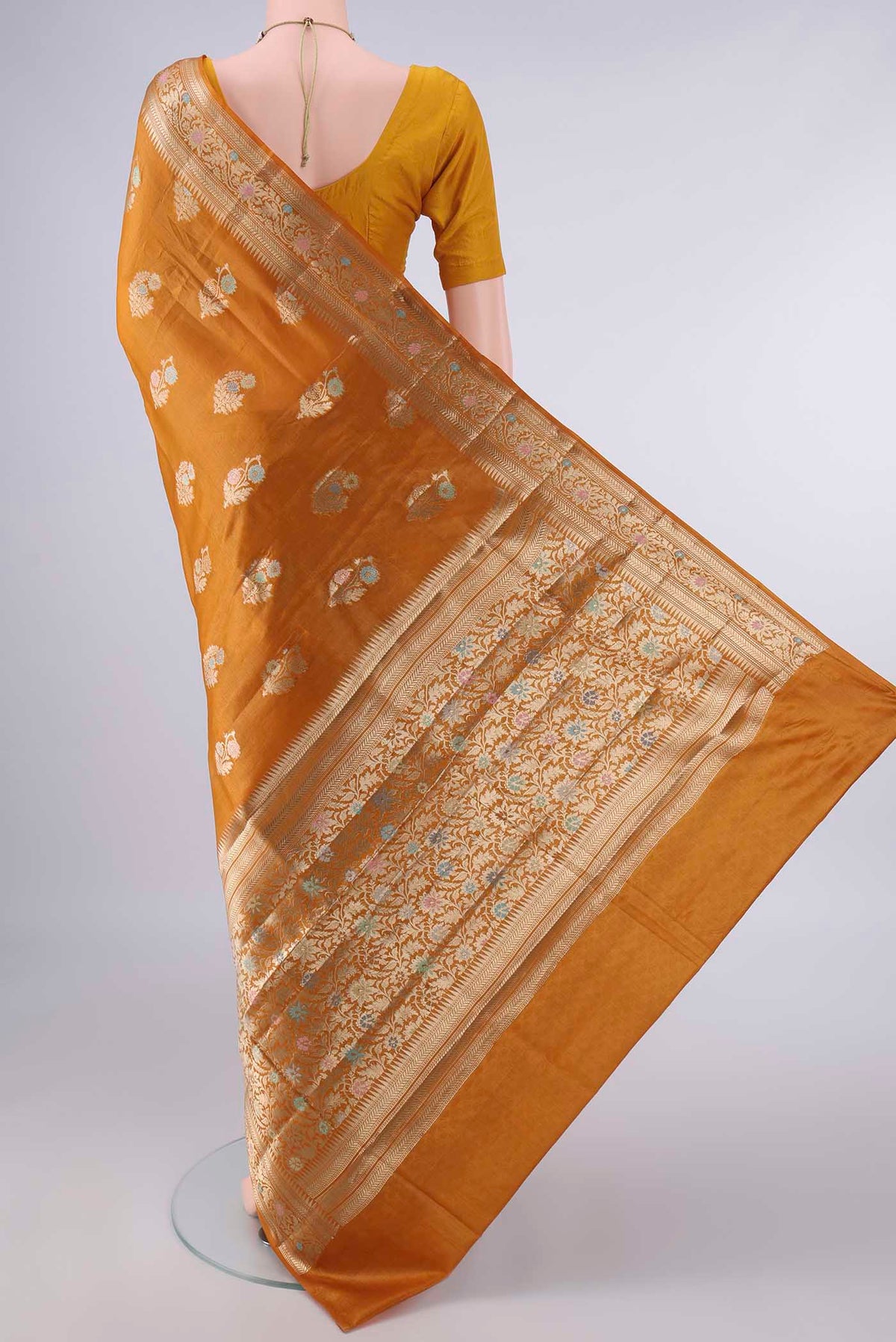 Flat view of Mustard Banarasi Tussar Saree with Zari And Thread Butta on the body and Zari Border. 