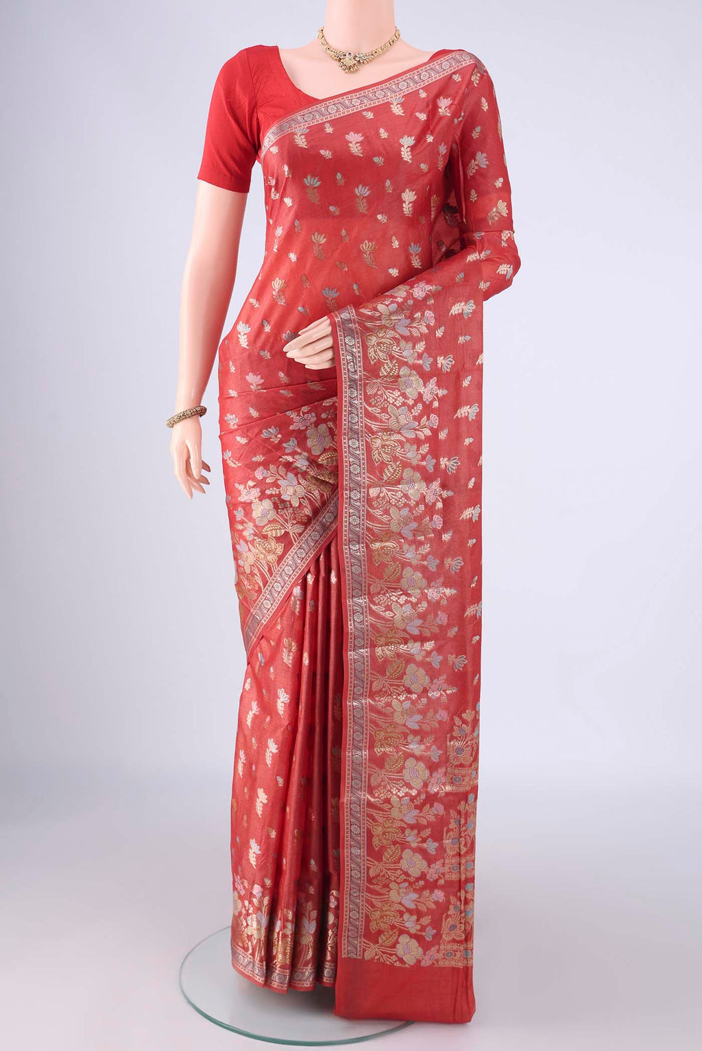 Rust Banarasi Tussar Silk Saree with Zari And Thread Butta on the body and Zari Border.  displayed on a mannequin