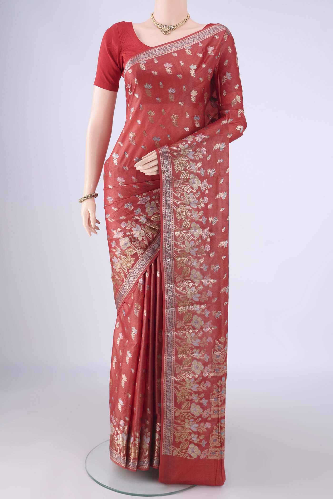 Rust Banarasi Tussar Silk Saree with Zari And Thread Butta on the body and Zari Border.  displayed on a mannequin
