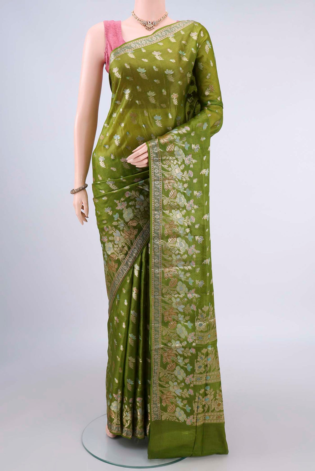 Green Banarasi Tussar Saree with Zari And Thread Butta on the body and Zari Border.  displayed on a mannequin