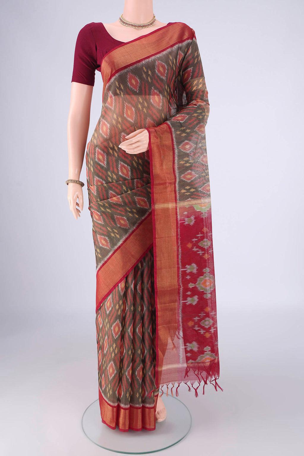 Grey Silk Cotton Saree with Ikat design on the body and Zari Border.  displayed on a mannequin