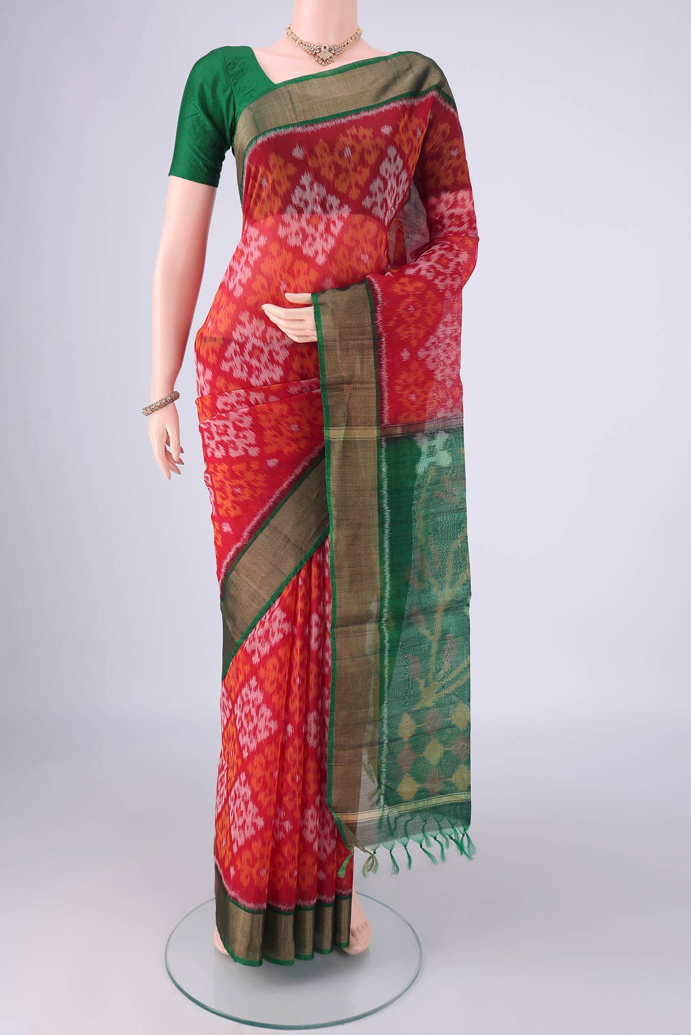 Red Silk Cotton Saree with Ikat design on the body and Zari Border.  displayed on a mannequin