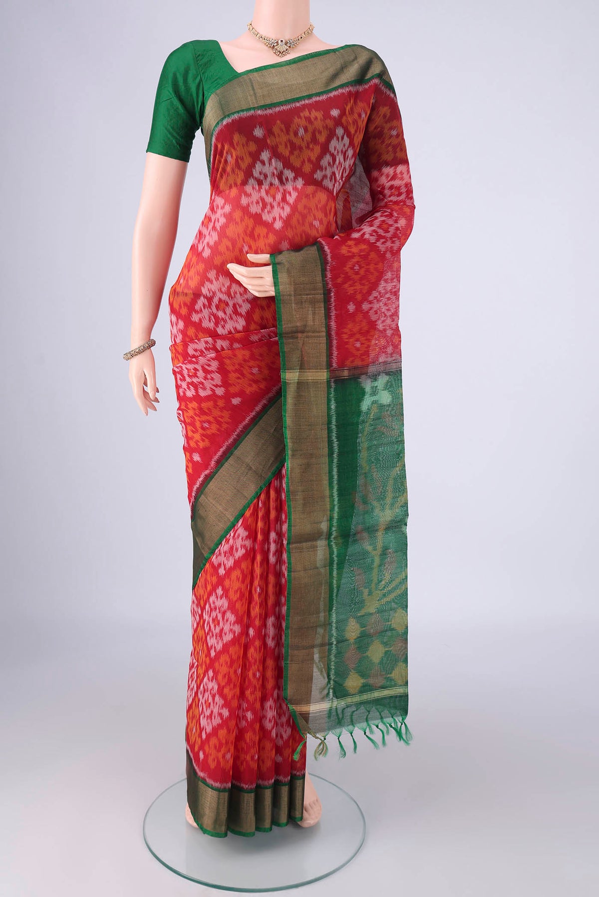 Red Silk Cotton Saree with Ikat design on the body and Zari Border.  displayed on a mannequin