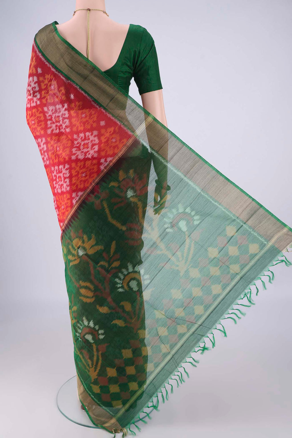 Flat view of Red Silk Cotton Saree with Ikat design on the body and Zari Border. 