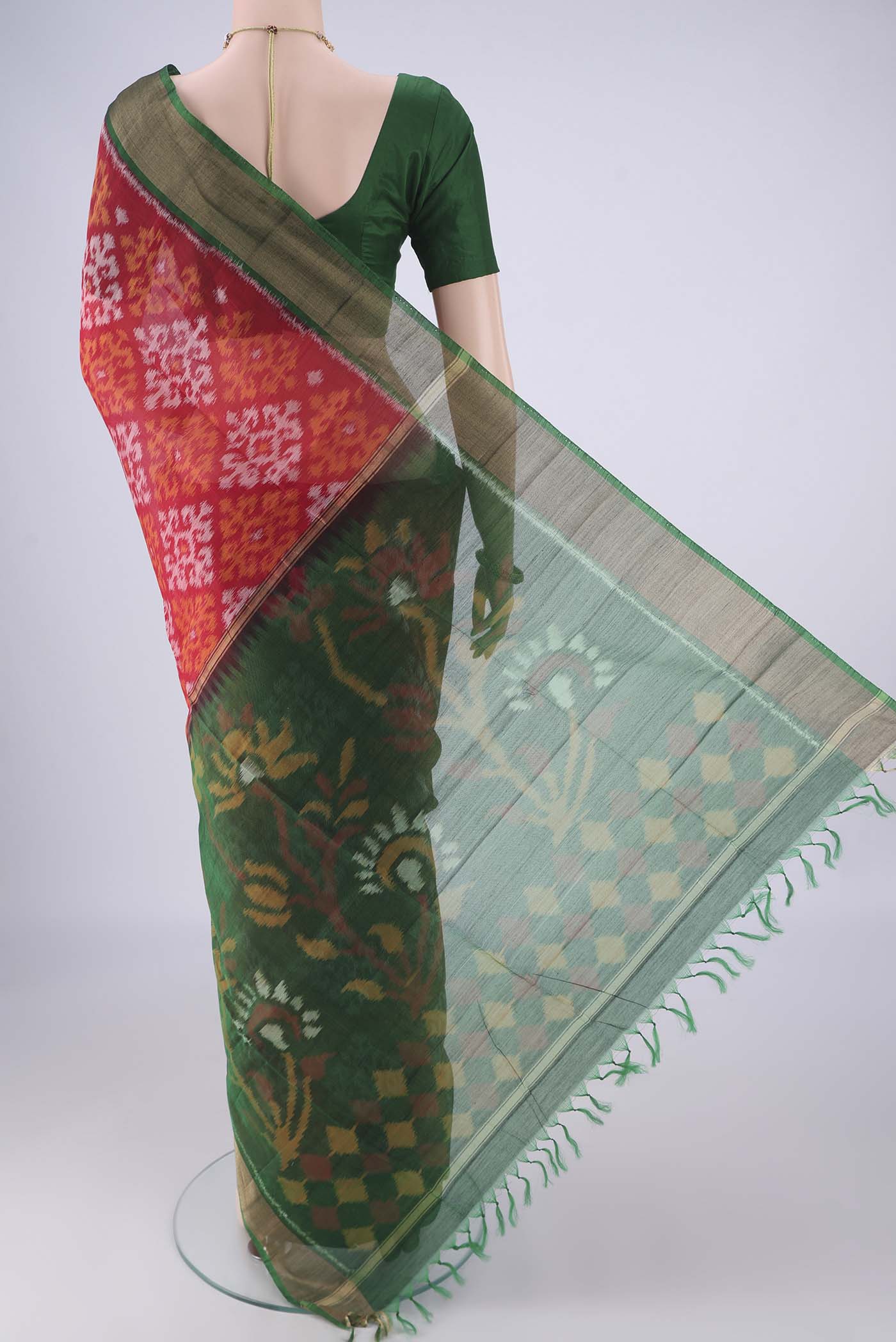Flat view of Red Silk Cotton Saree with Ikat design on the body and Zari Border. 
