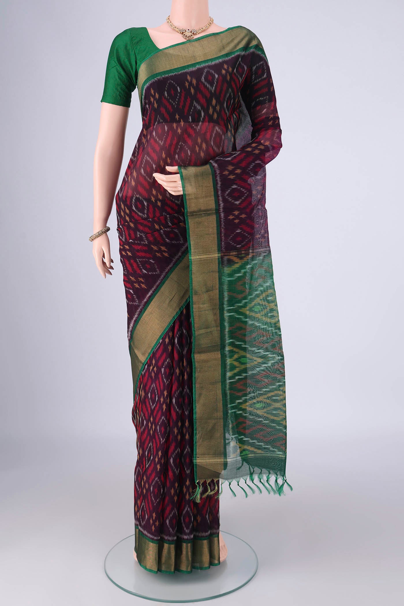 Purple Silk Cotton Saree with Ikat design on the body and Zari Border.  displayed on a mannequin