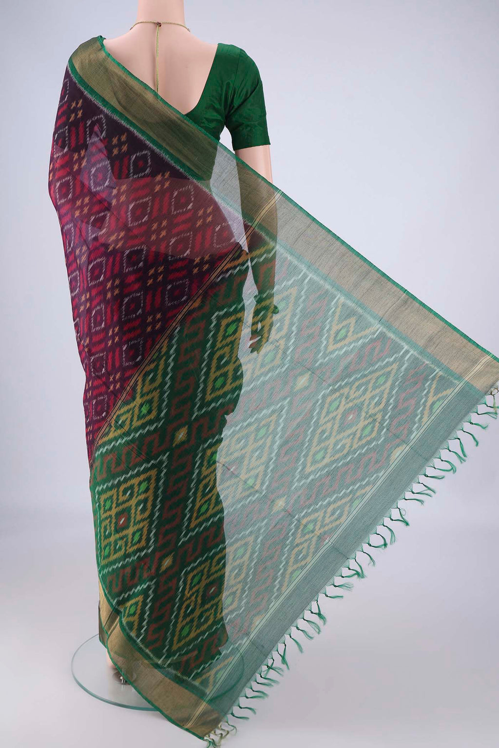 Flat view of Purple Silk Cotton Saree with Ikat design on the body and Zari Border. 