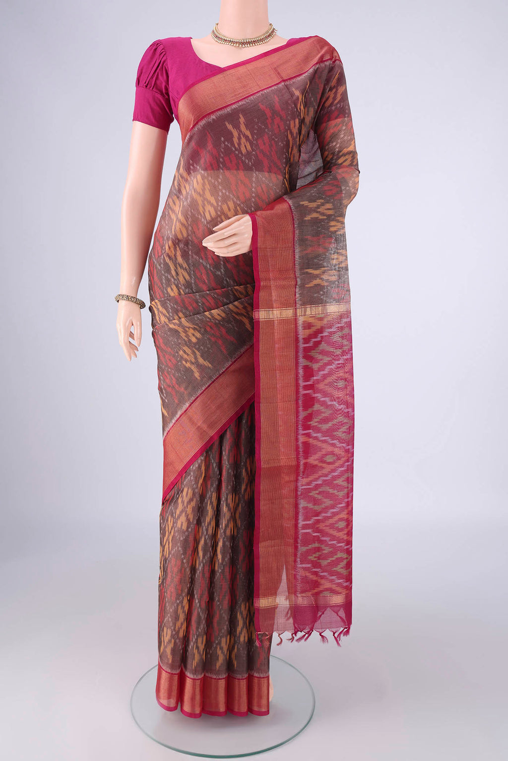 Davys Grey Silk Cotton Saree with Ikat design on the body and Zari Border.  displayed on a mannequin