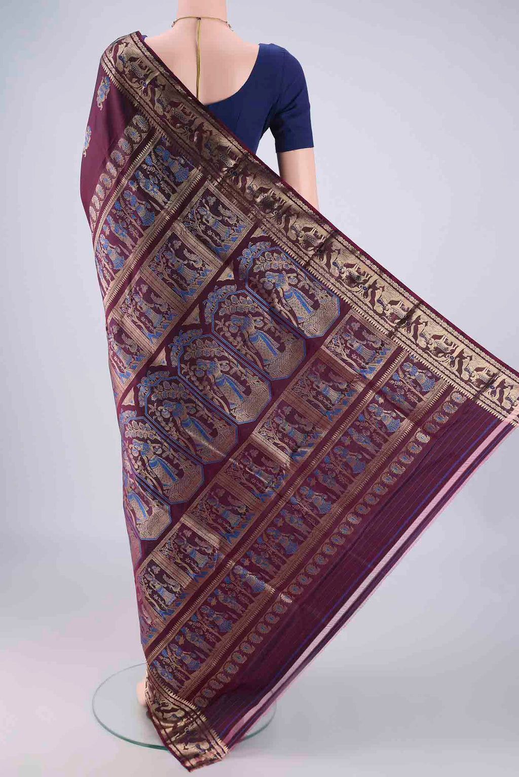 Flat view of Burgundy Baluchari Silk Saree with Zari And Thread Butta on the body and Zari And Thread Border. 