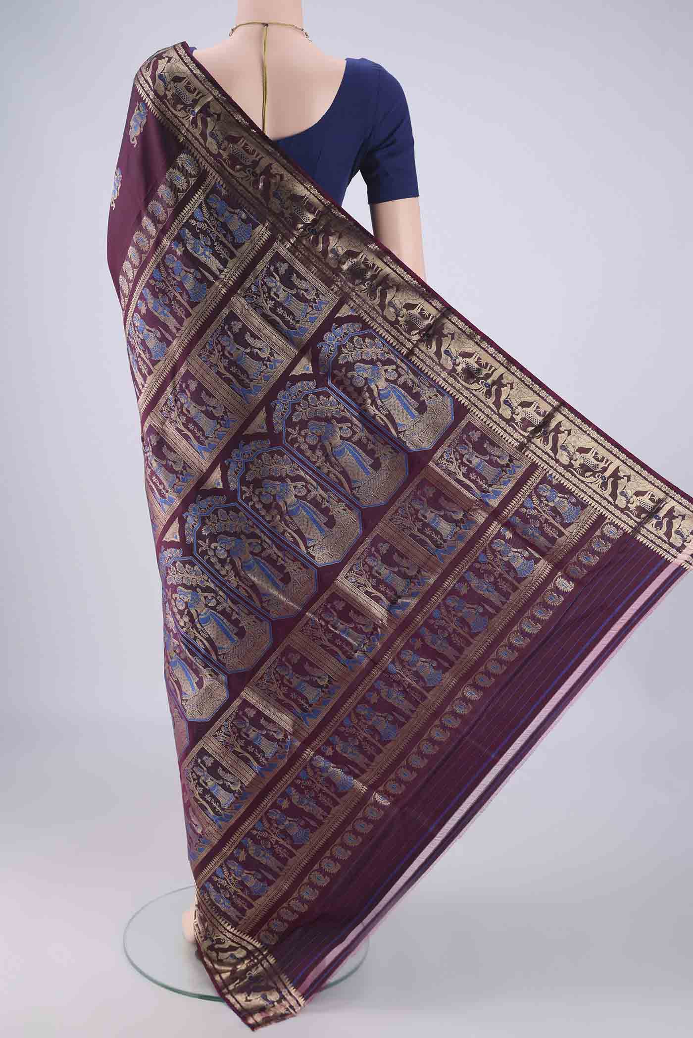 Flat view of Burgundy Baluchari Silk Saree with Zari And Thread Butta on the body and Zari And Thread Border. 