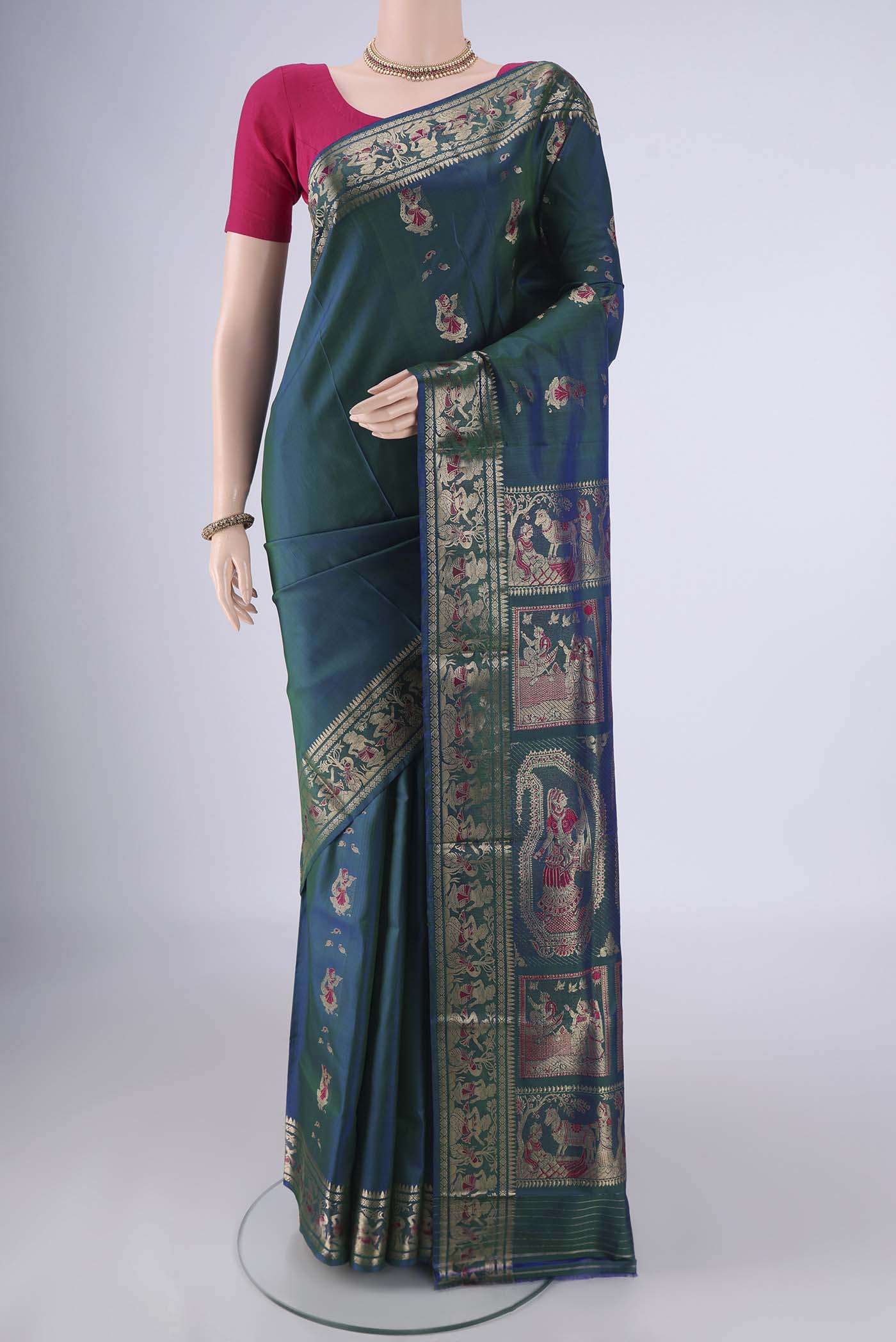 Peacock Blue Dual Tone Baluchari Silk Saree with Zari And Thread Butta on the body and Zari And Thread Border.  displayed on a mannequin