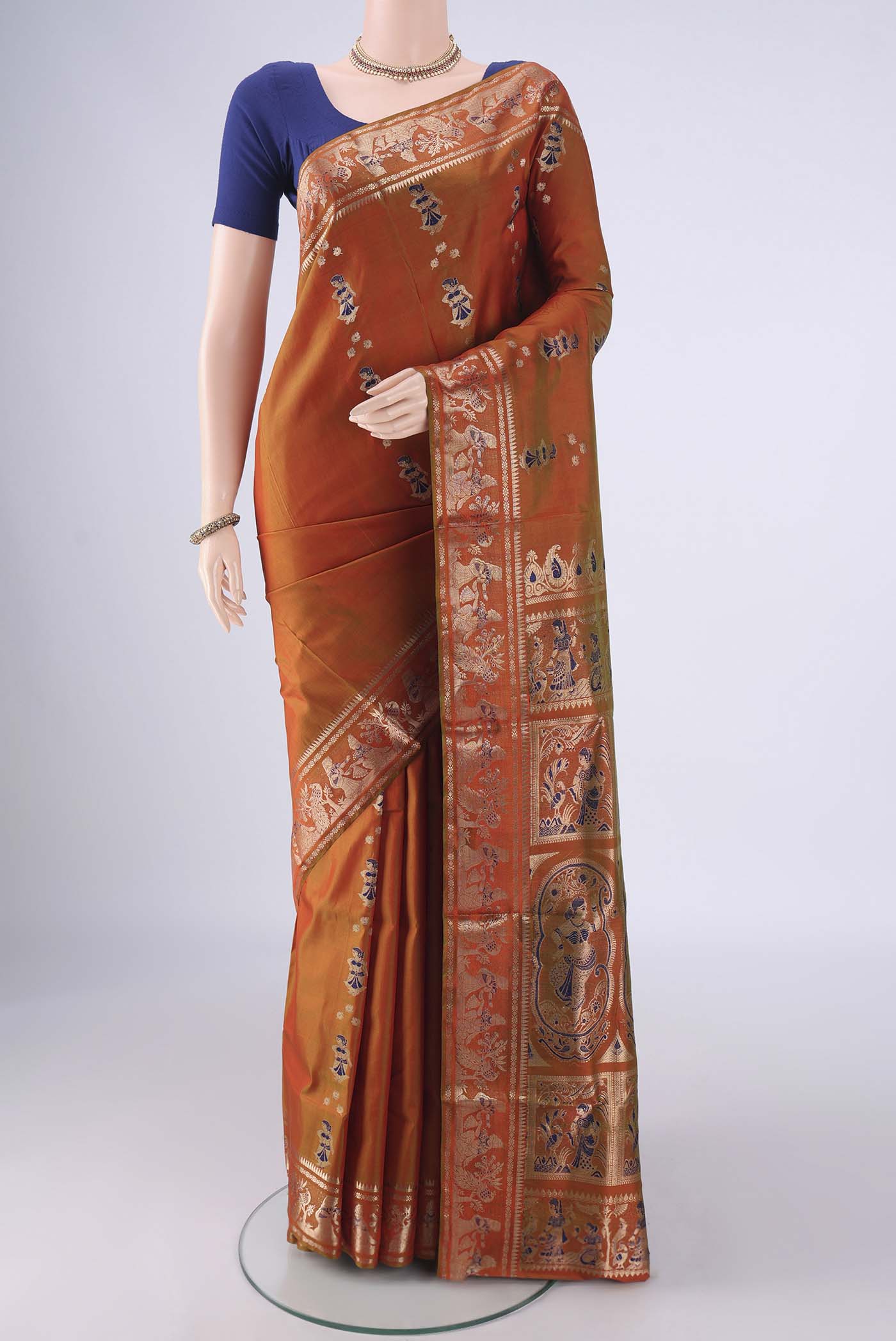 Rust Dual Tone Baluchari Silk Saree with Zari And Thread Butta on the body and Zari And Thread Border.  displayed on a mannequin