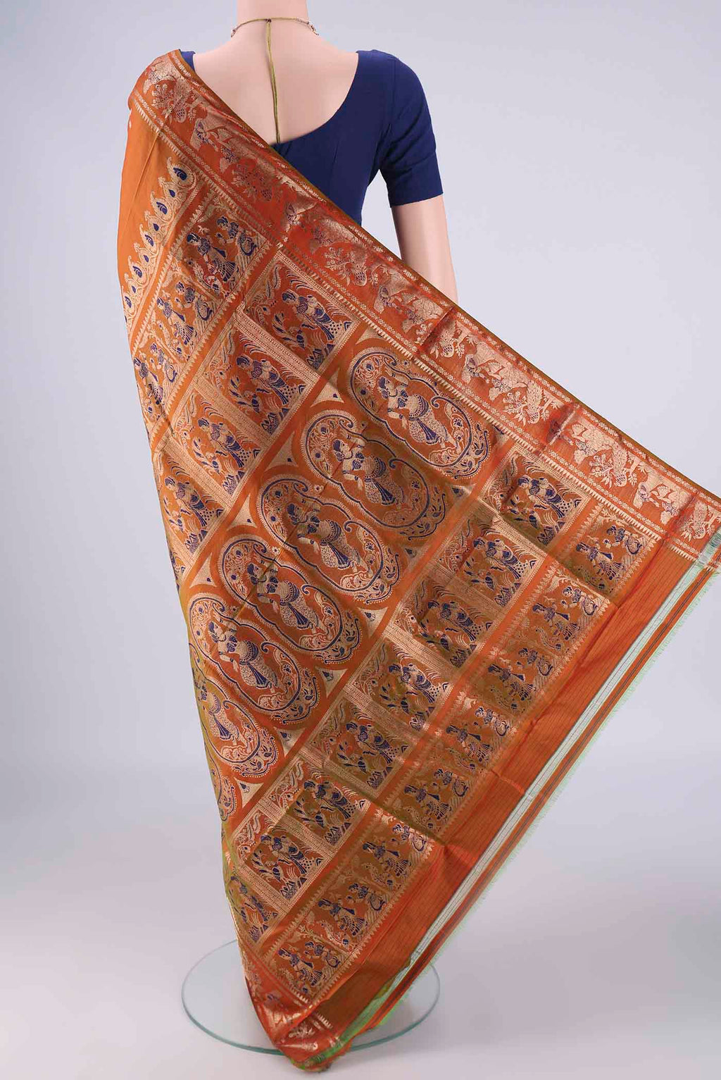 Flat view of Rust Dual Tone Baluchari Silk Saree with Zari And Thread Butta on the body and Zari And Thread Border. 