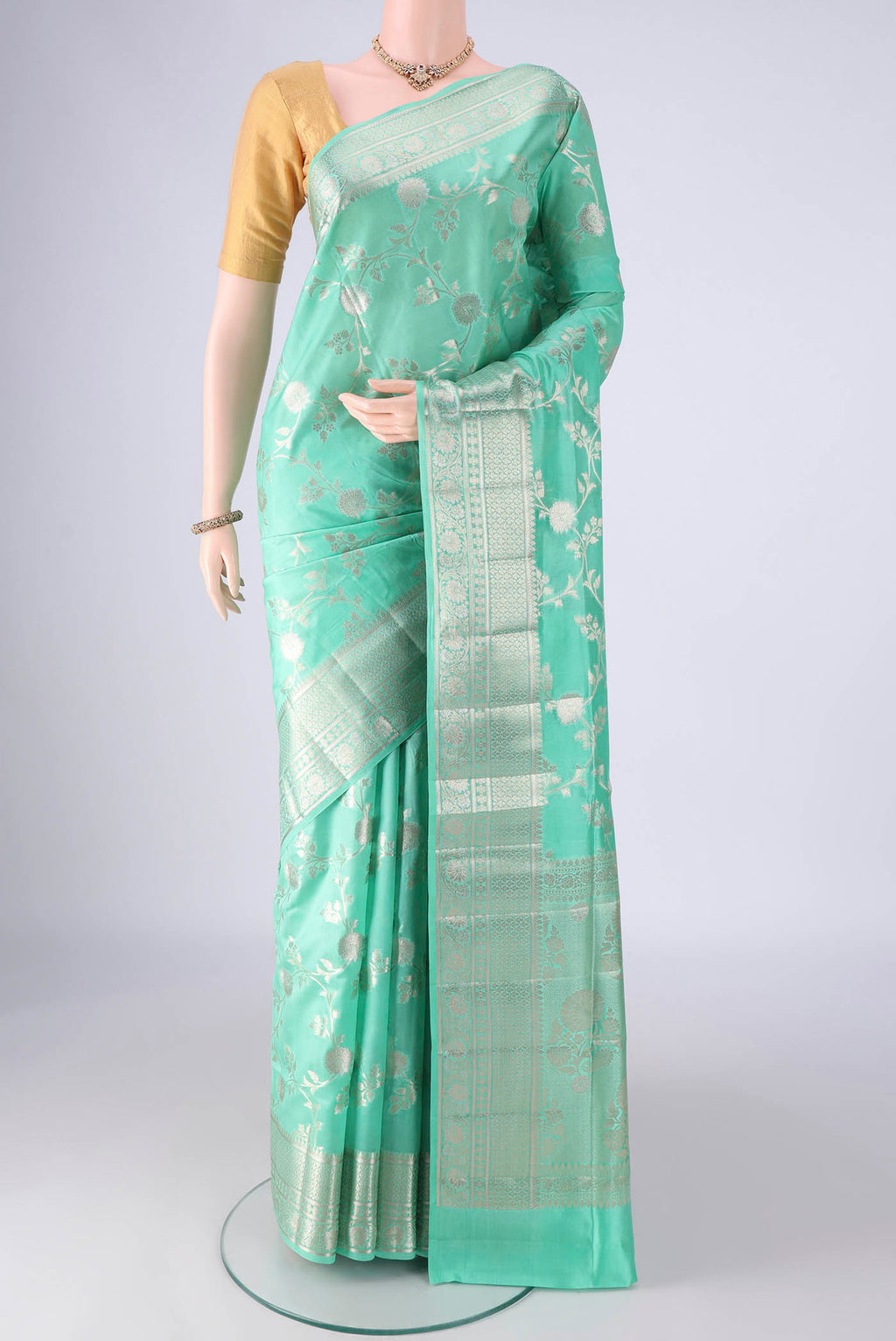 Turquoise Banarasi Raw Silk Saree with Zari Brocade on the body and Zari Border.  displayed on a mannequin