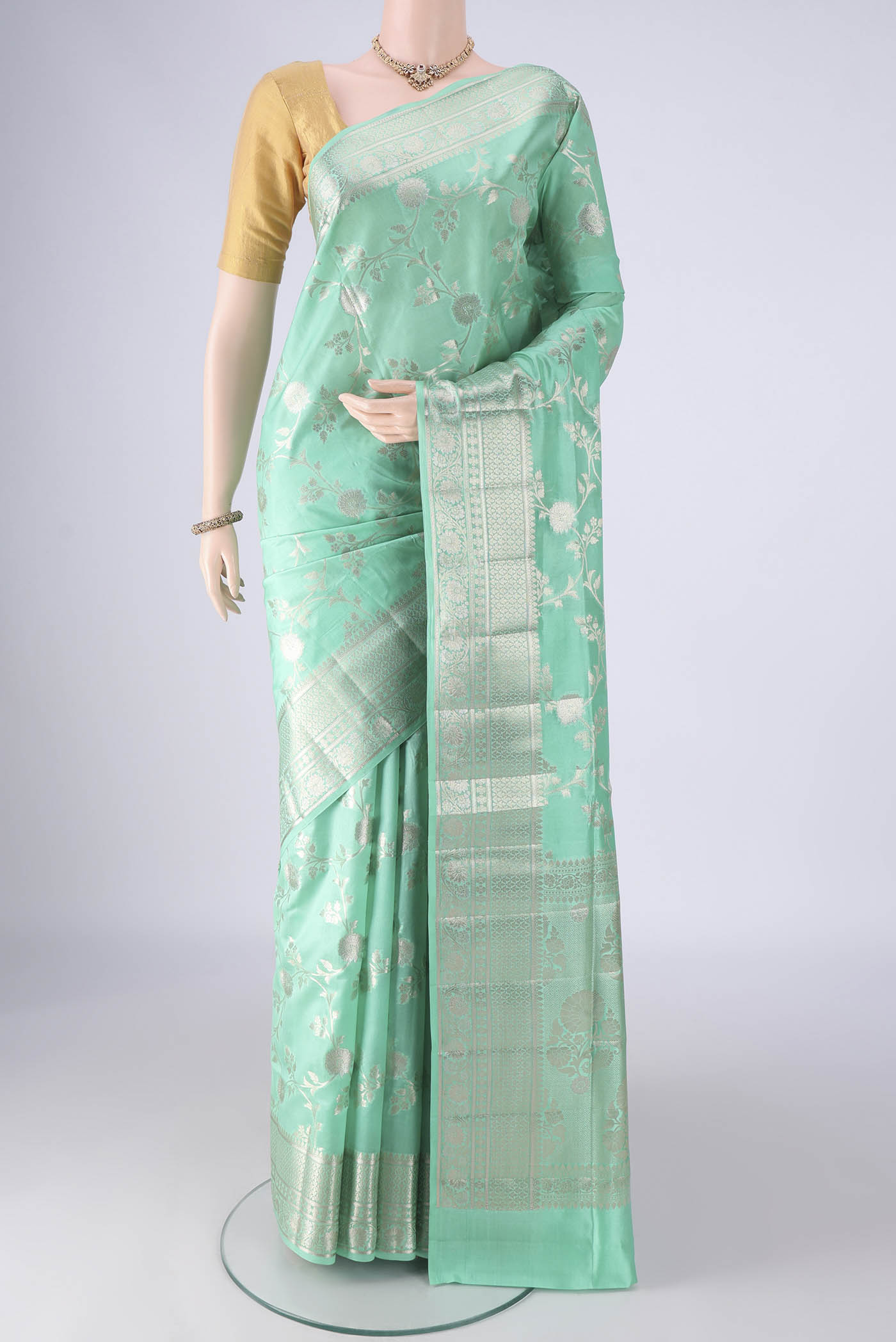 Turquoise Banarasi Raw Silk Saree with Zari Brocade on the body and Zari Border.  displayed on a mannequin