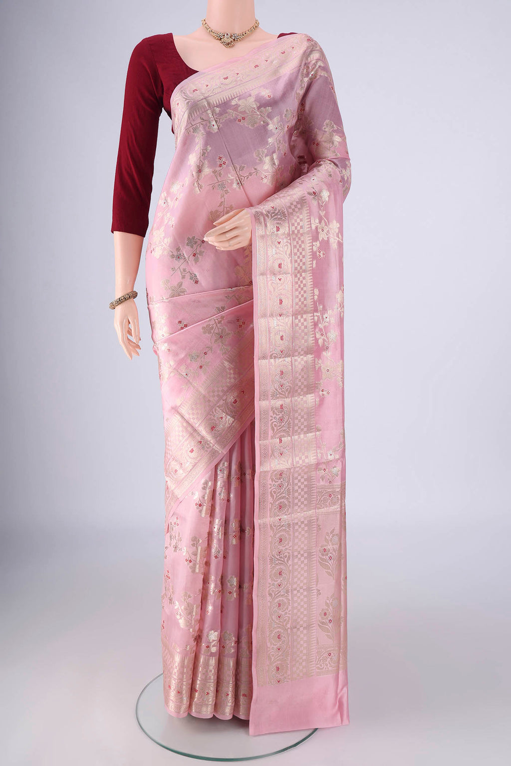 Rose pink Banarasi Raw Silk Saree with Zari And Thread Butta on the body and Zari And Thread Border.  displayed on a mannequin