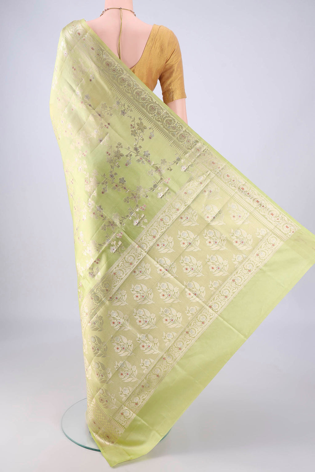 Flat view of Pista Green Banarasi Raw Silk Saree with Zari And Thread Butta on the body and Zari Border. 