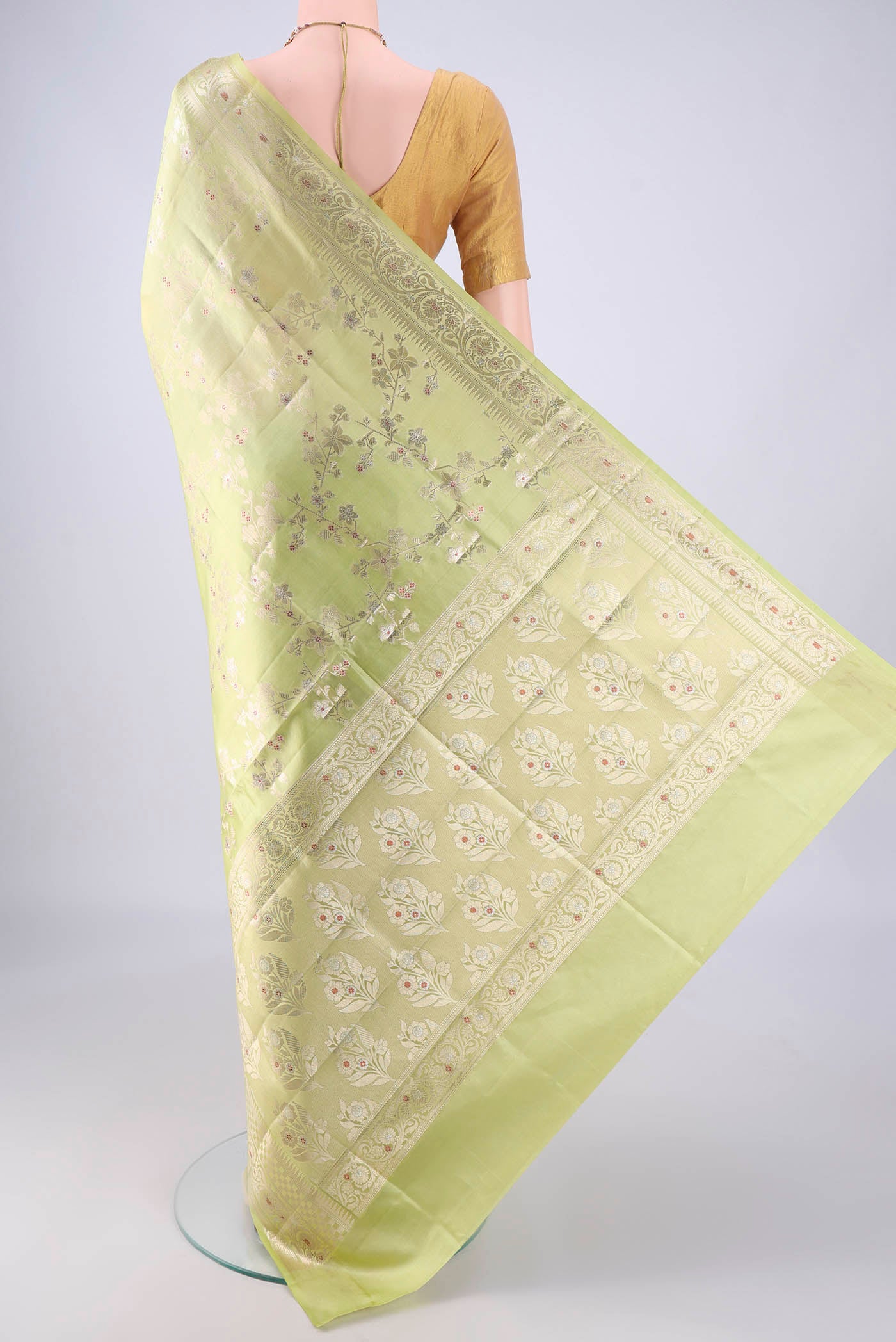 Flat view of Pista Green Banarasi Raw Silk Saree with Zari And Thread Butta on the body and Zari Border. 