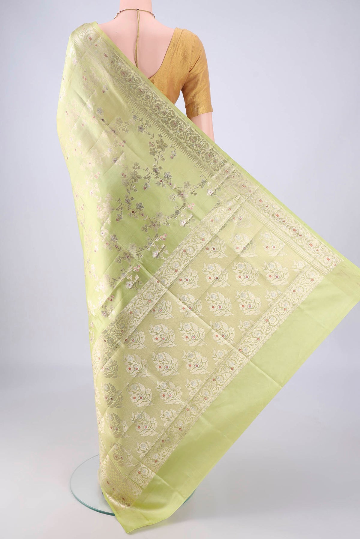 Flat view of Pista Green Banarasi Raw Silk Saree with Zari And Thread Butta on the body and Zari Border. 