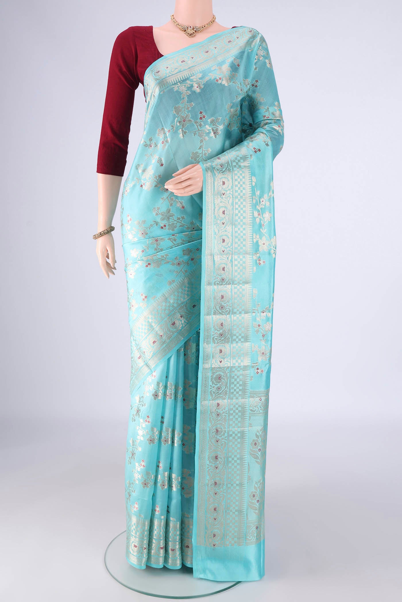 Sky Blue Banarasi Raw Silk Saree with Zari And Thread Butta on the body and Zari And Thread Border.  displayed on a mannequin