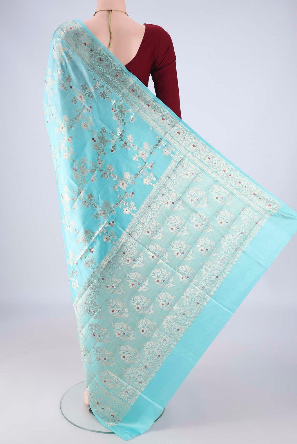 Flat view of Sky Blue Banarasi Raw Silk Saree with Zari And Thread Butta on the body and Zari And Thread Border. 