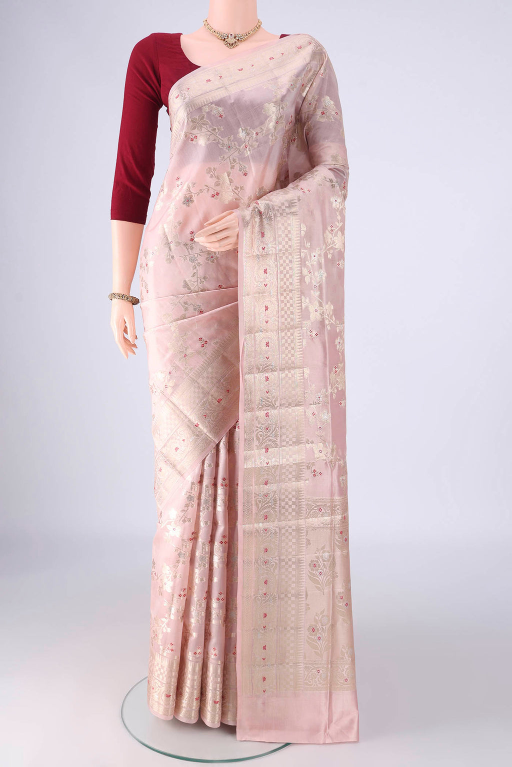 Rose Gold Banarasi Raw Silk Saree with Zari Brocade on the body and Zari And Thread Border.  displayed on a mannequin