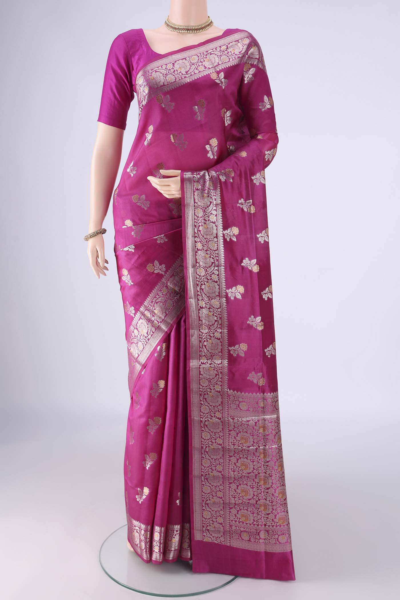 Rani Pink Banarasi Raw Silk Saree with Zari Butta on the body and Zari Border.  displayed on a mannequin
