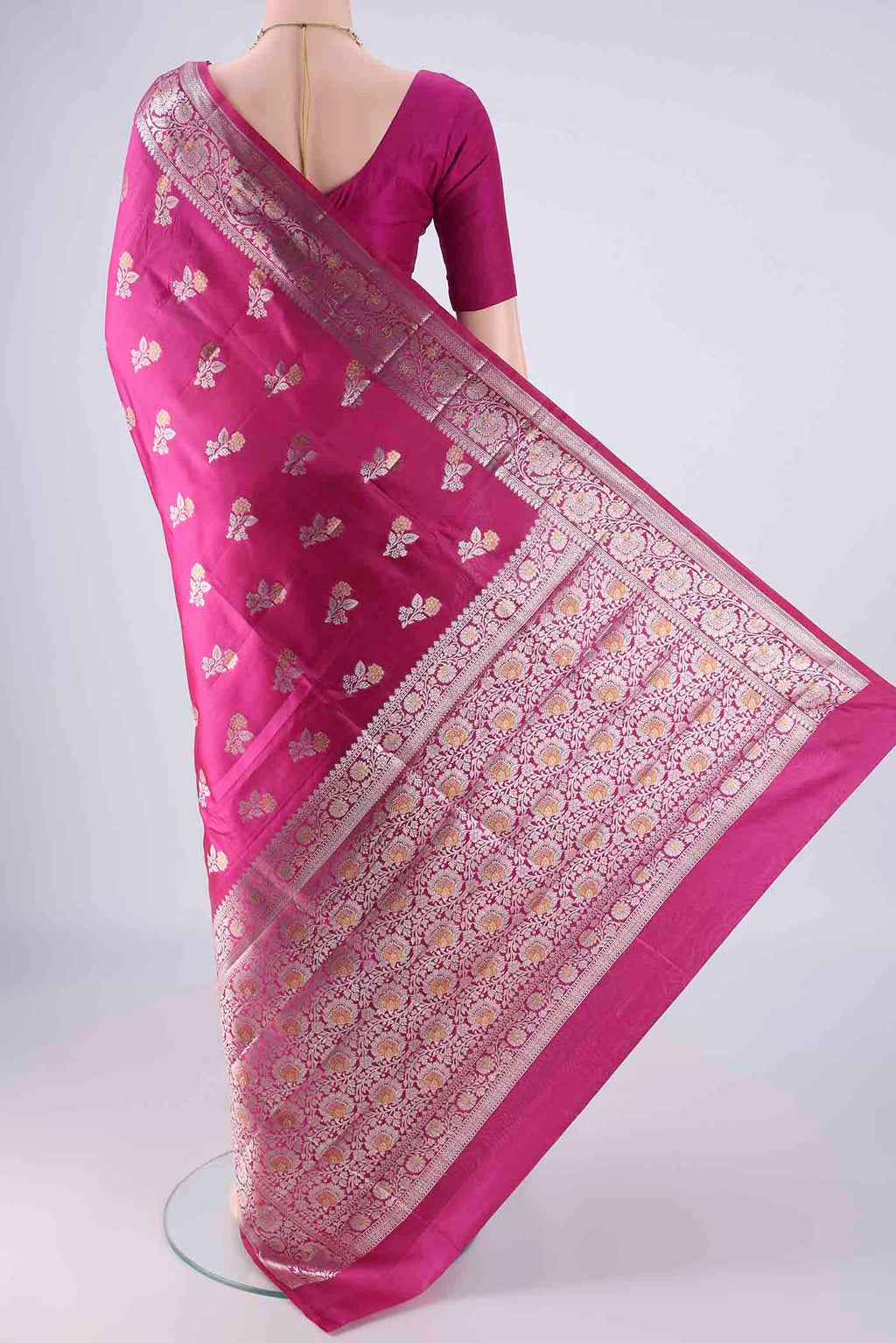 Flat view of Rani Pink Banarasi Raw Silk Saree with Zari Butta on the body and Zari Border. 