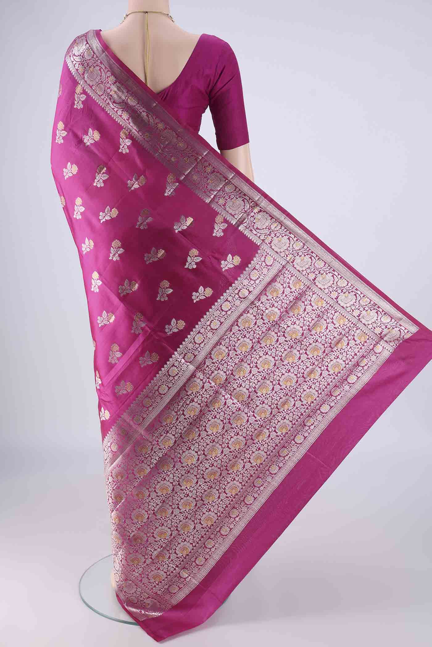 Flat view of Rani Pink Banarasi Raw Silk Saree with Zari Butta on the body and Zari Border. 
