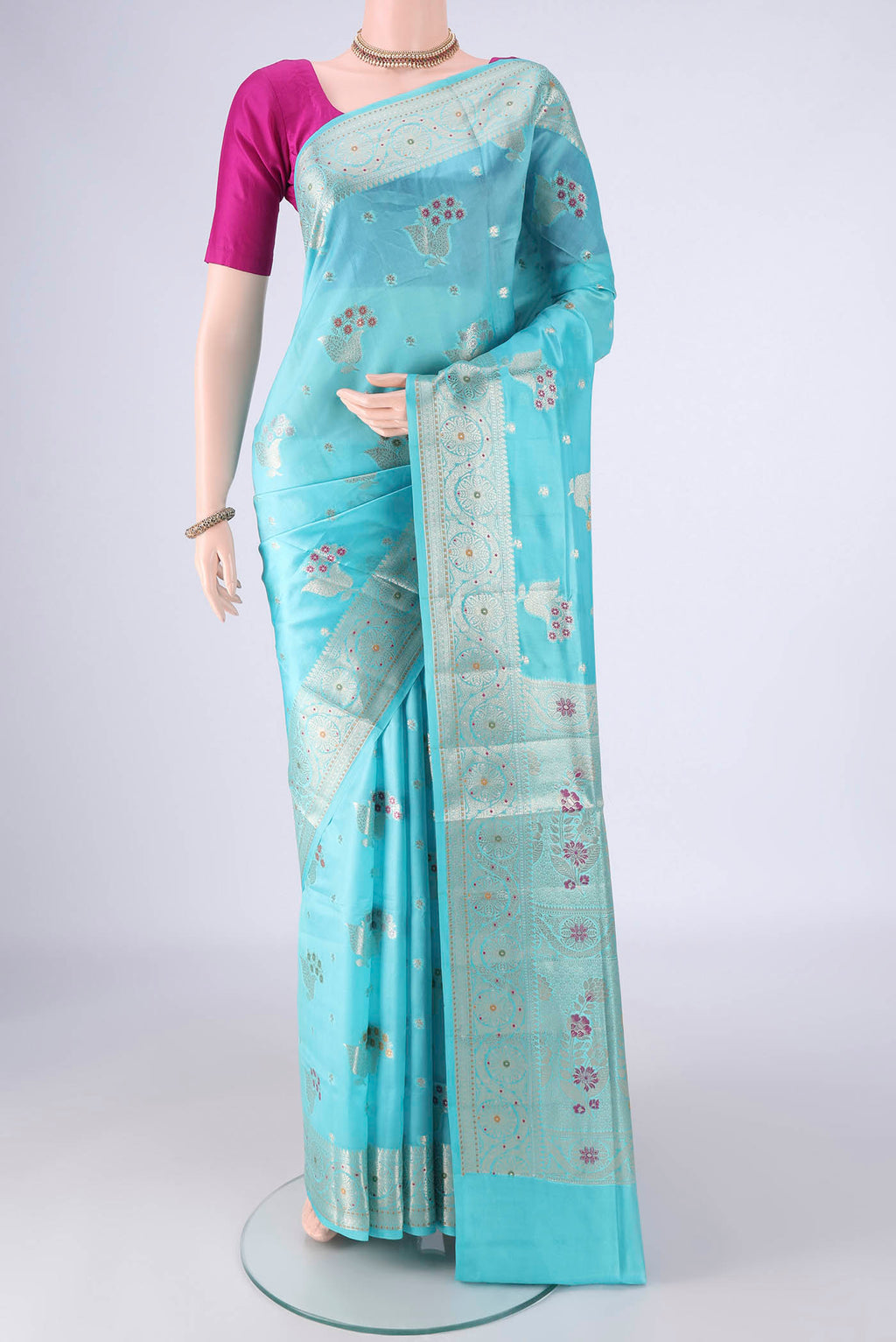 Sky Blue Banarasi Raw Silk Saree with Zari And Thread Butta on the body and Zari And Thread Border.  displayed on a mannequin