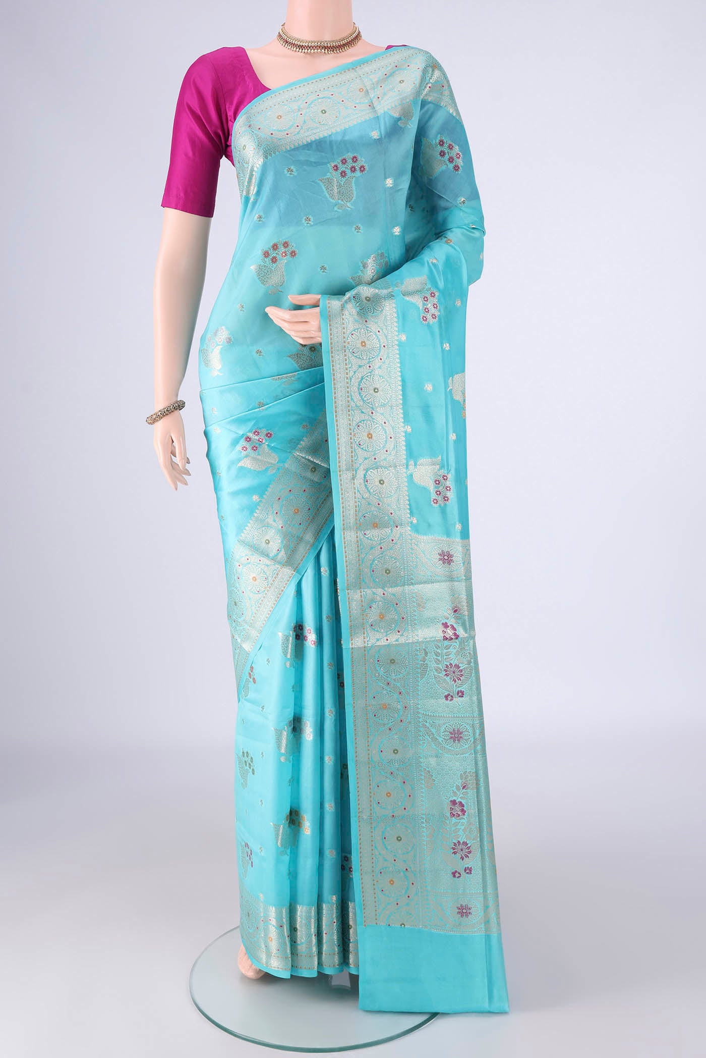 Sky Blue Banarasi Raw Silk Saree with Zari And Thread Butta on the body and Zari And Thread Border.  displayed on a mannequin